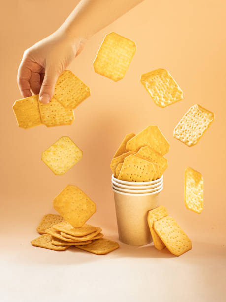 istock crackers in a glass on a yellow background 1874091233