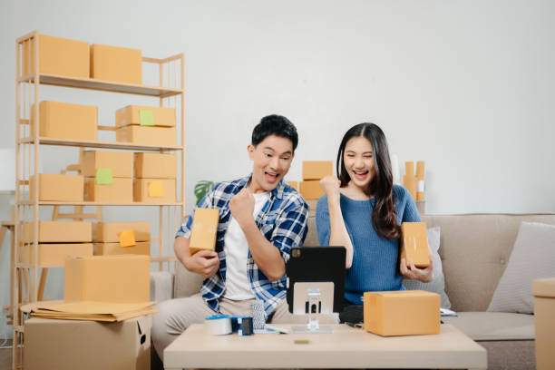 istock Starting small businesses SME owners, two check online orders Selling products working with boxs freelance work at home office 1874099506