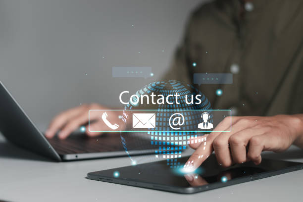 istock Customer support center contact us. Businessman using computer laptop with contact icons on virtual screen for customer support hotline and people connection. 1874101000
