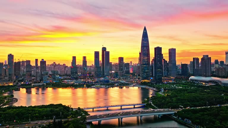 Aerial drone footage of city skyline and modern building at sunset in Shenzhen