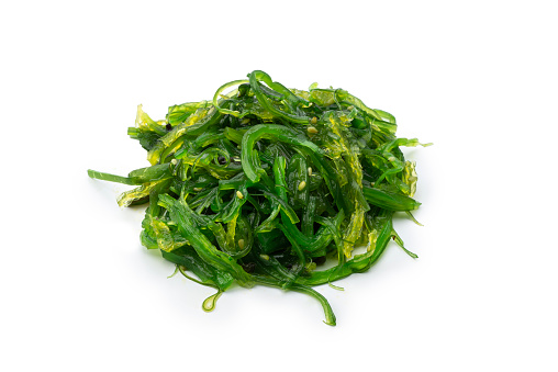 Heap of organic Japanese Wakame salad isolated on white background, high angle view, studio shot.