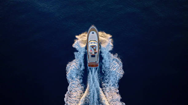 Yacht cruising fast in sea Aerial view of luxury yacht moving fast at Adriatic sea during sunny day. sea wake stock pictures, royalty-free photos & images