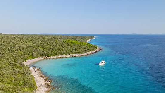 Aerial view of luxury yacht anchored in Adriatic sea during sunny day.