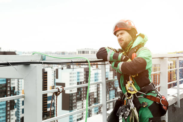 istock Portrait industrial mountaineering worker in uniform on roof 1874147420