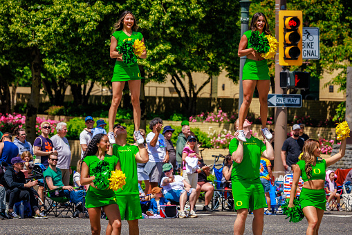 Portland, Oregon, USA - June 10, 2023: University of Oregon Cheerleaders in the Grand Floral Parade, during Portland Rose Festival 2023.