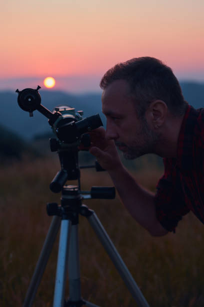 istock Astronomer looking at the sun with a telescope. 1874160638