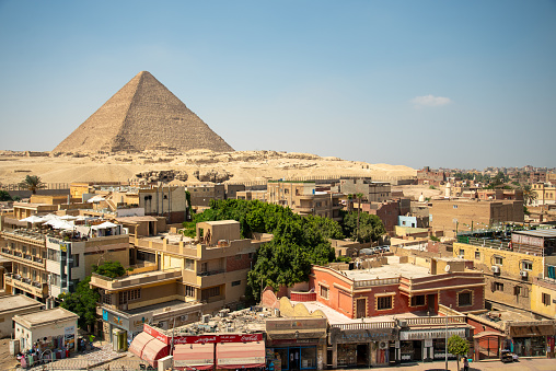 Traffic raises dust and pollution near the pyramids of Khafre and Khufu in Cairo, Egypt.