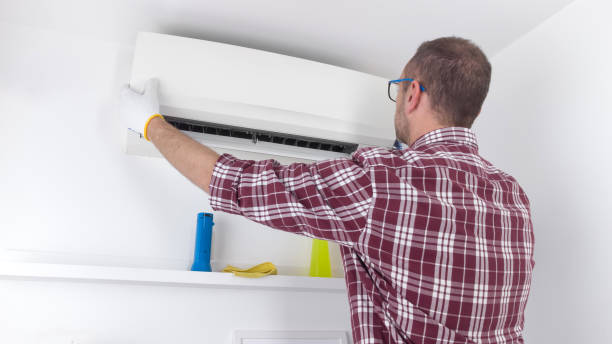 istock Service guy cleaning and maintaining air condition unit. 1874171722