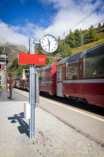Holidays in Switzerland - Bernina Express stopped in Pontresina train station. The well-known Bernina Railway, which has been a UNESCO World Heritage Site since 2008, links the spa resort of St. Moritz over the Bernina Pass with the Italian town of Tirano.