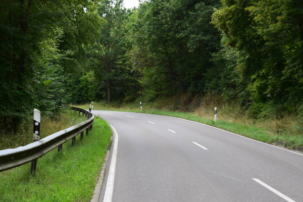 istock country road curve in the fores 1874205390