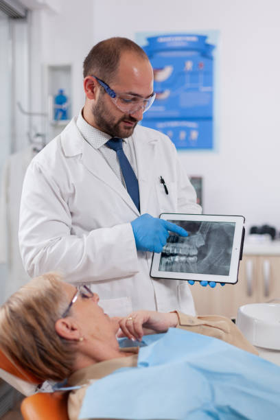 istock Dentist in dental cabinet explaining tooth diagnosis 1874208117