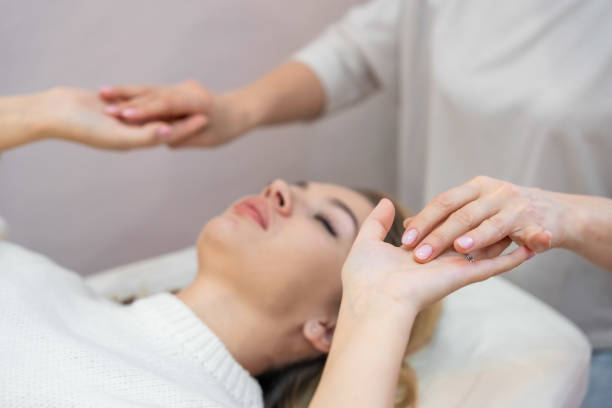 istock Healer launches body energy through hands before access bars therapy with young woman, stimulating positive change thoughts and emotions. Alternative medicine concept. 1874210834