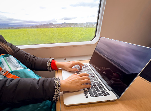 Nomad digital woman hand  as she is a freelance working  a vacation with laptop in  the train