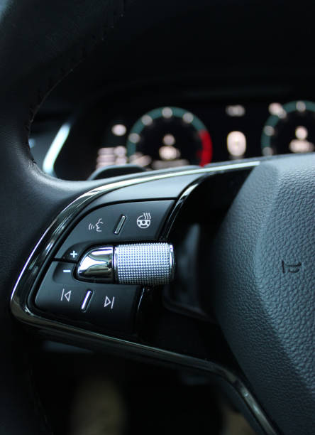 istock Heated steering wheel control buttons with blurred dashboard in car interior 1874220017