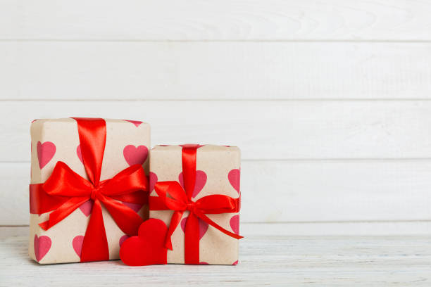 istock gift box with red bow and red heart on colored background. Perspective view. Flat lay 1874221126