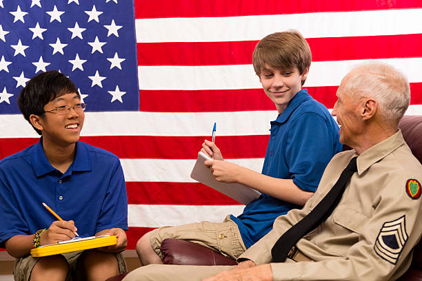 Military: Teenage boys interview a military veteran.