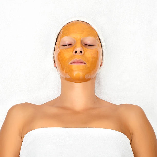 Facial mask Young Woman with facial mask at beauty salon  face mask stock pictures, royalty-free photos & images