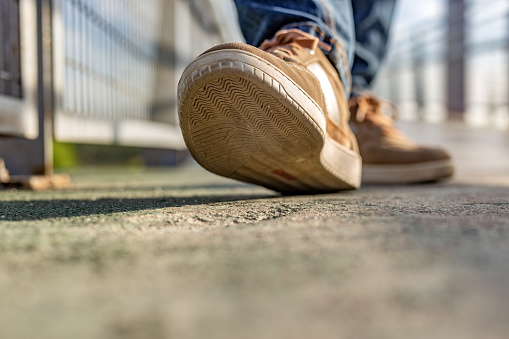 Young lady walking in the countryside in autumn and foot detail