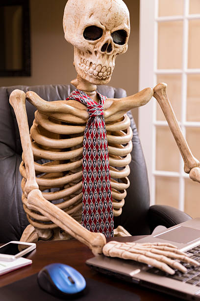 istock Business: Skeleton of man who worked himself to death. 187423233