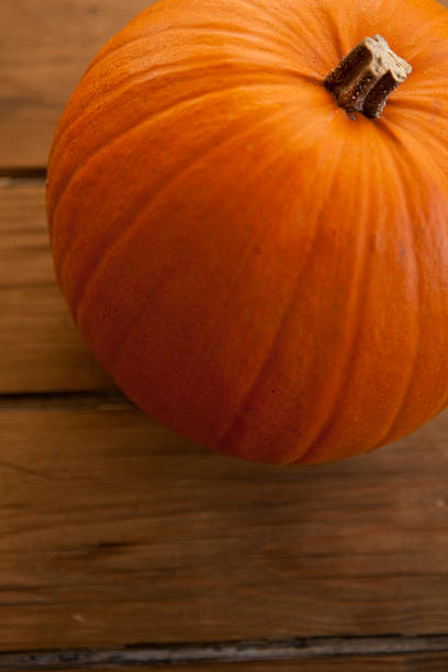 istock Pumpkin against wooden background 187423545