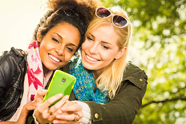 istock Two girls taking pictures with a Smartphone 187423549