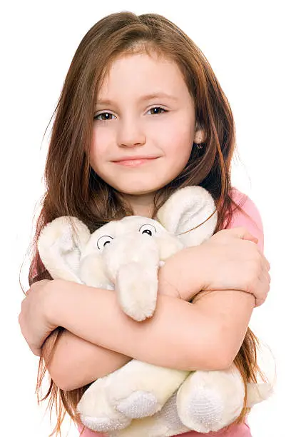 Photo of Portrait of smiling little girl with a teddy elephant