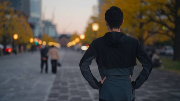 istock Male runner athlete walking in city after training 1874236879