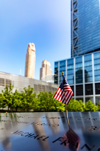 New York, USA; June 1, 2023: An American flag at the World Trade Center memorial, honoring the victims of the terrorist attack.