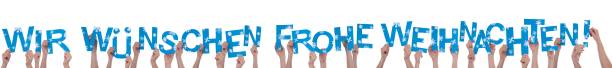istock Many Hands Holding We Wish Merry Christmas 187427339