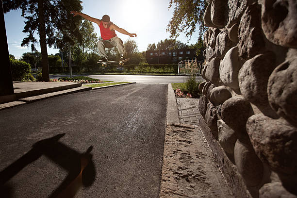istock Skateboarder doing a Ollie trick in the street 187427785