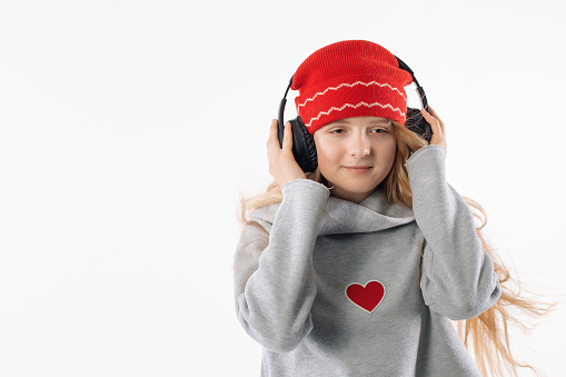 Girl in a red hat with headphones