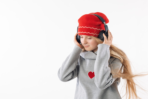 Long haired girl in a red hat with headphones