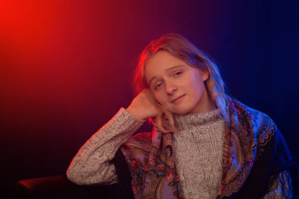 Cropped portrait of tender young woman posing against gradient studio background in yellow neon light. Self-expression. Gel portrait. Concept of natural beauty, anti aging, cosmetology, female health.