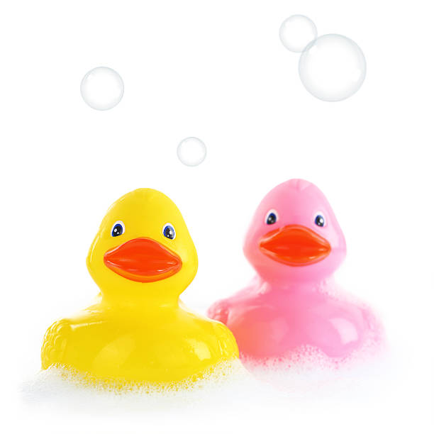 istock Yellow and pink rubber ducks in bath foam 187429712