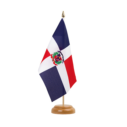 A beautiful miniature Dominican Republic desk flag isolated on a white background. The little pennant is elegantly attached to a small wooden flag stand.