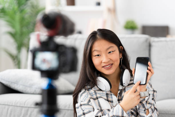 istock Chinese woman recording a video tutorial at home 1874327275