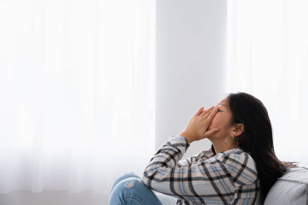 istock Desperate woman covering her face with hands crying 1874327801