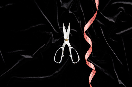 Top View Of Scissors And Tape Measure On Black Velvet