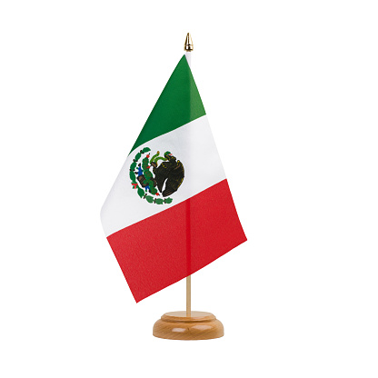 A beautiful miniature Mexico desk flag isolated on a white background. The little pennant is elegantly attached to a small wooden flag stand.