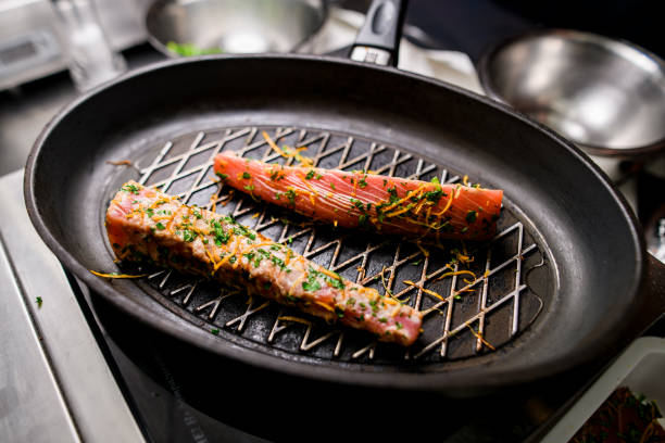 istock Front view of two grilled red fish salmon steaks on cast iron skillet pan 1874332159