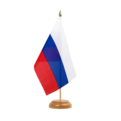 A beautiful miniature Russia desk flag isolated on a white background. The little pennant is elegantly attached to a small wooden flag stand.