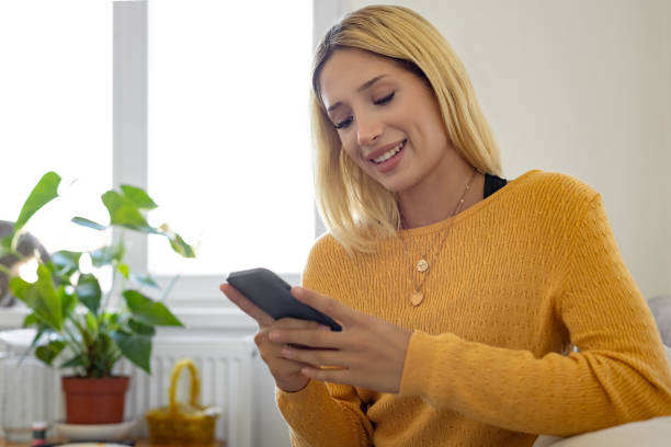 istock A happy young female using phone 1874337945