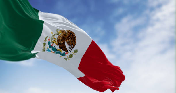 istock Mexico national flag waving on a clear day 1874366011