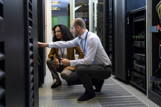 istock IT professionals having meeting in server room 1874366527