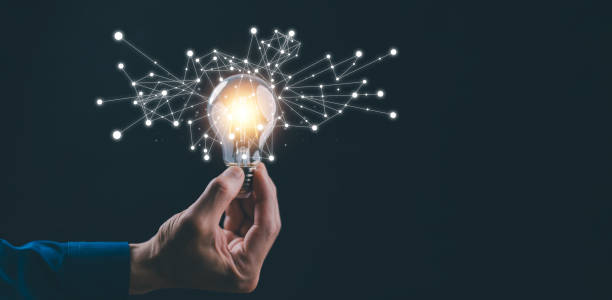 istock business hand holding illuminated light bulb, idea, innovation and inspiration concept.concept of creativity with bulbs that shine glitter, creativity with bulbs that shine glitter.Inspiration of idea 1874372808