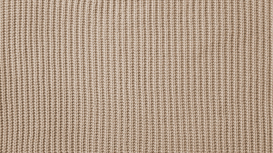 Knitted fabric wallpaper texture pattern background in sepia style. Backdrop for Design