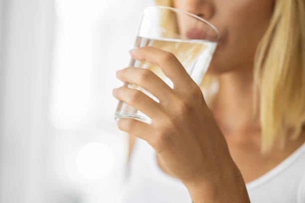 istock Woman drinking pure fresh mineral water 1874397080