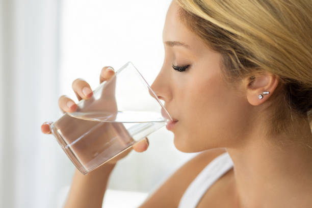istock Woman drinking pure fresh mineral water 1874398092
