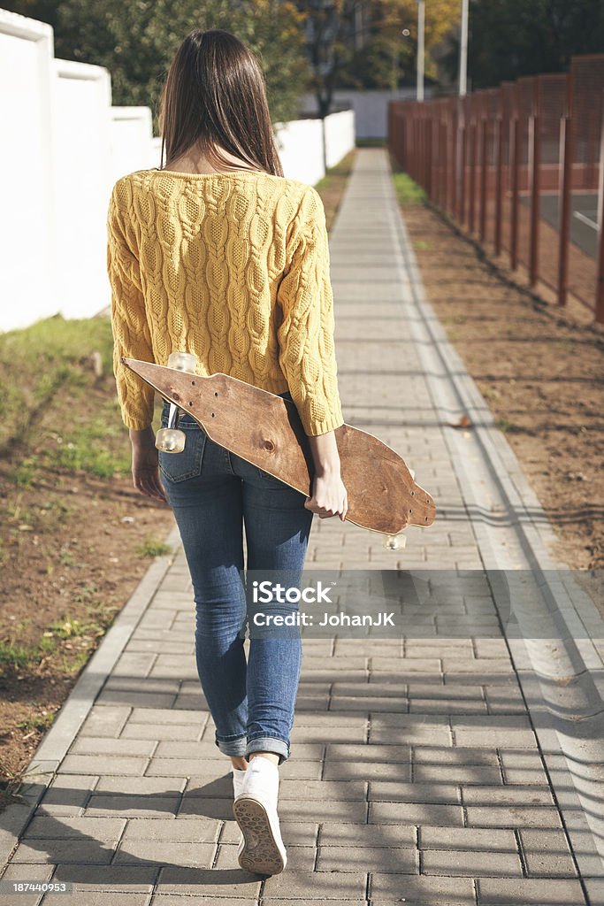 beautiful skater woman Beautiful young woman  walking with a longboard in the afternoon. Skateboarding. Outdoors, lifestyle Activity Stock Photo