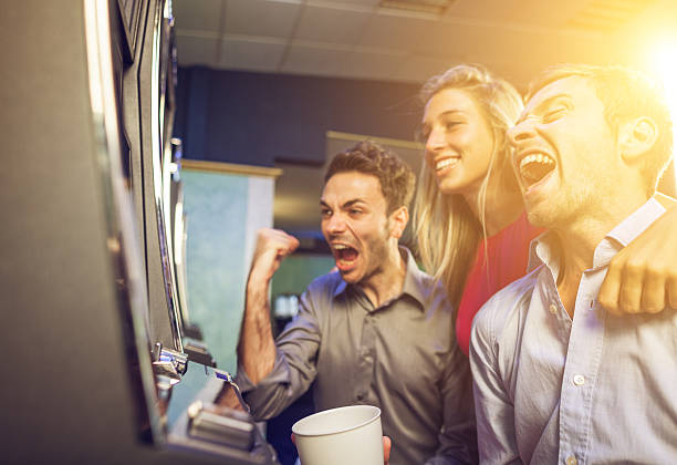 istock People playing slot machine at casino 187441259